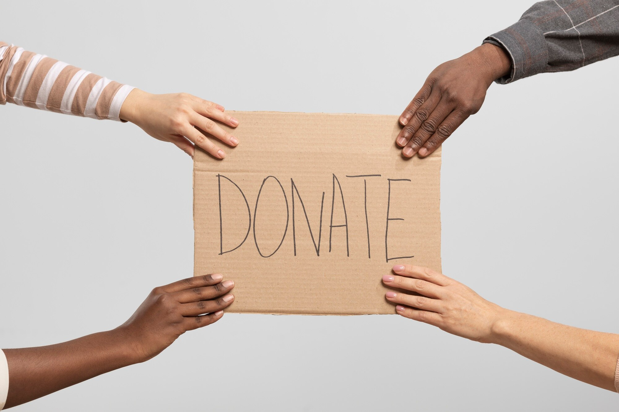 Donate sign being held by hands